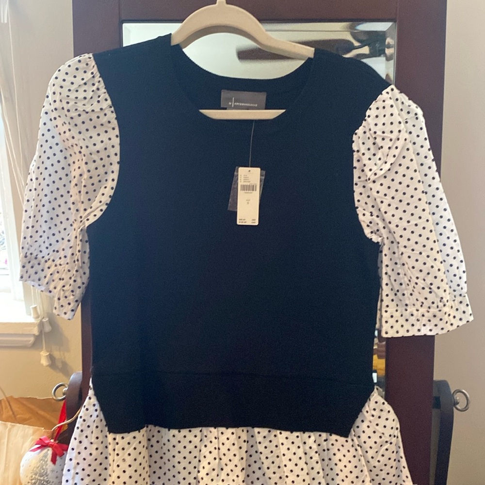 Anthropologie black sweater with polka dots.